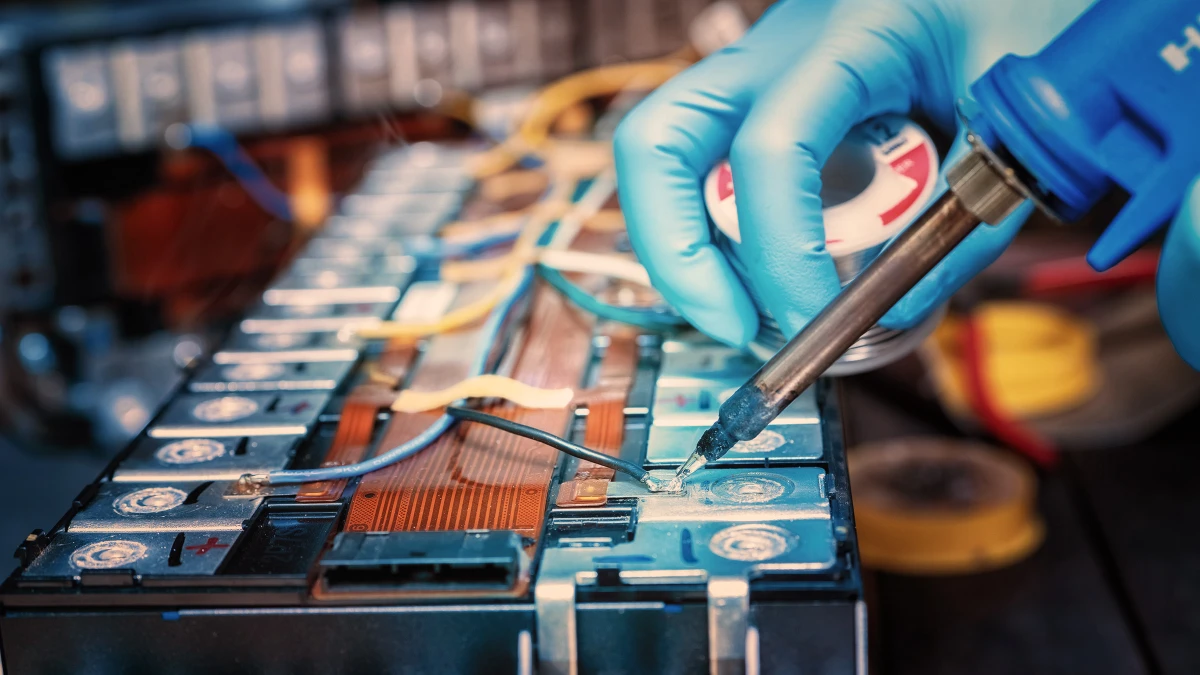 An engineer soldering a part of a lithium ion battery.