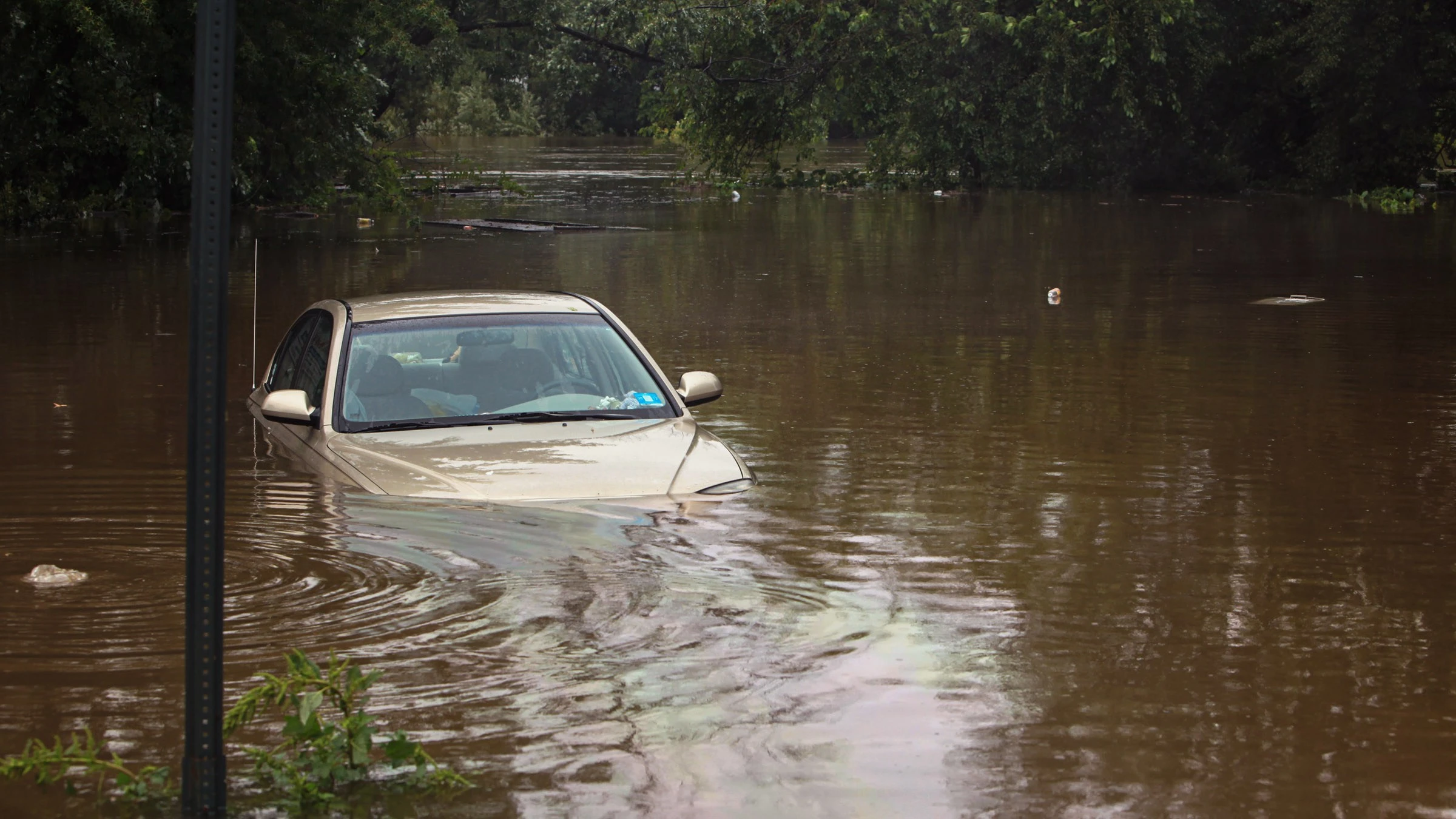 A vehicle submerged in flood waters.