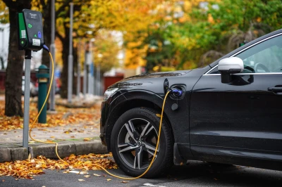 An electric vehicle charging at a public station.